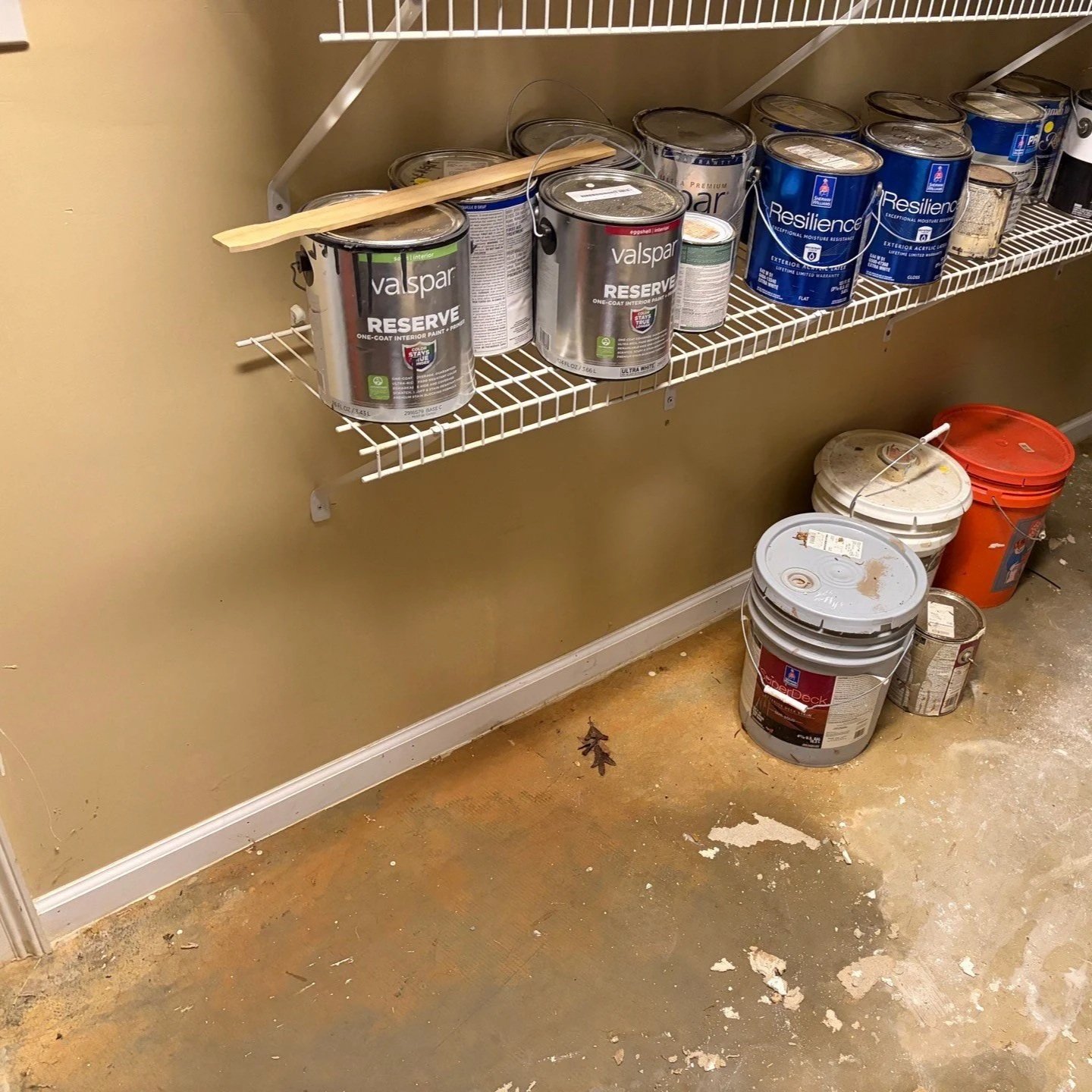 Basement workshop wall and floor damaged by water