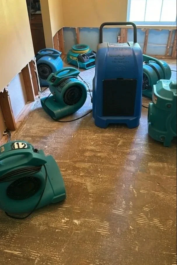 ServiceMaster drying equipment set after damaged flooring and drywall removed in Dining Room