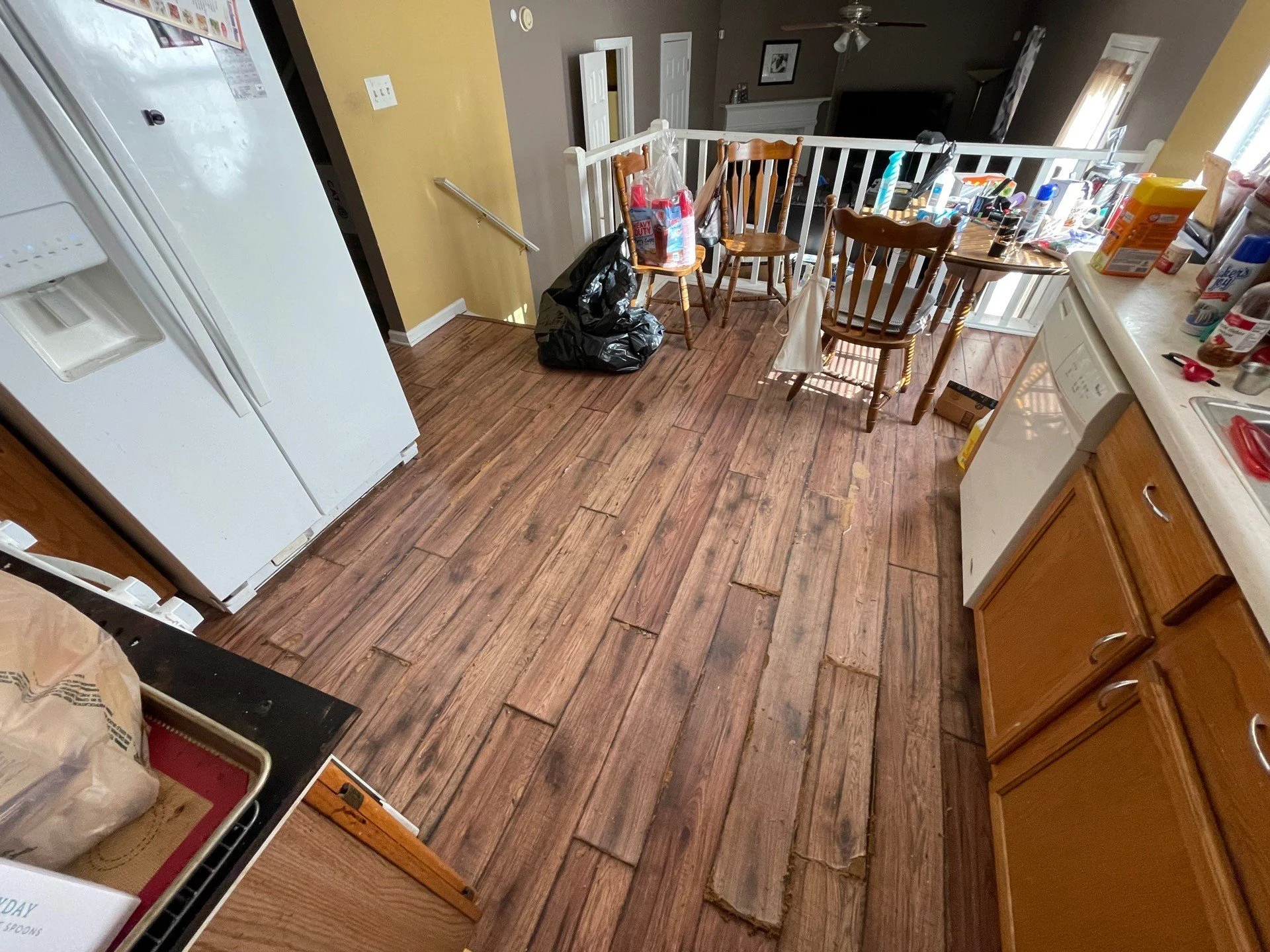 Water damaged flooring in Kitchen from refrigerator leak