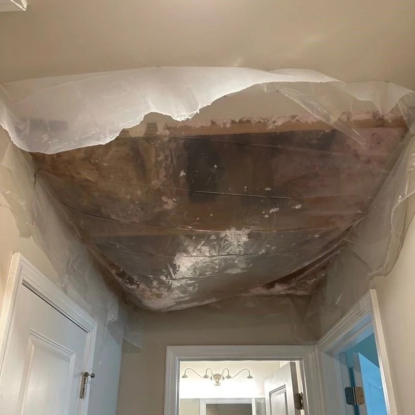 Hallway ceiling drywall damaged by HVAC leak removed and hole covered by ServiceMaster