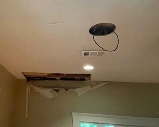 Damaged basement living room ceiling after pipe burst