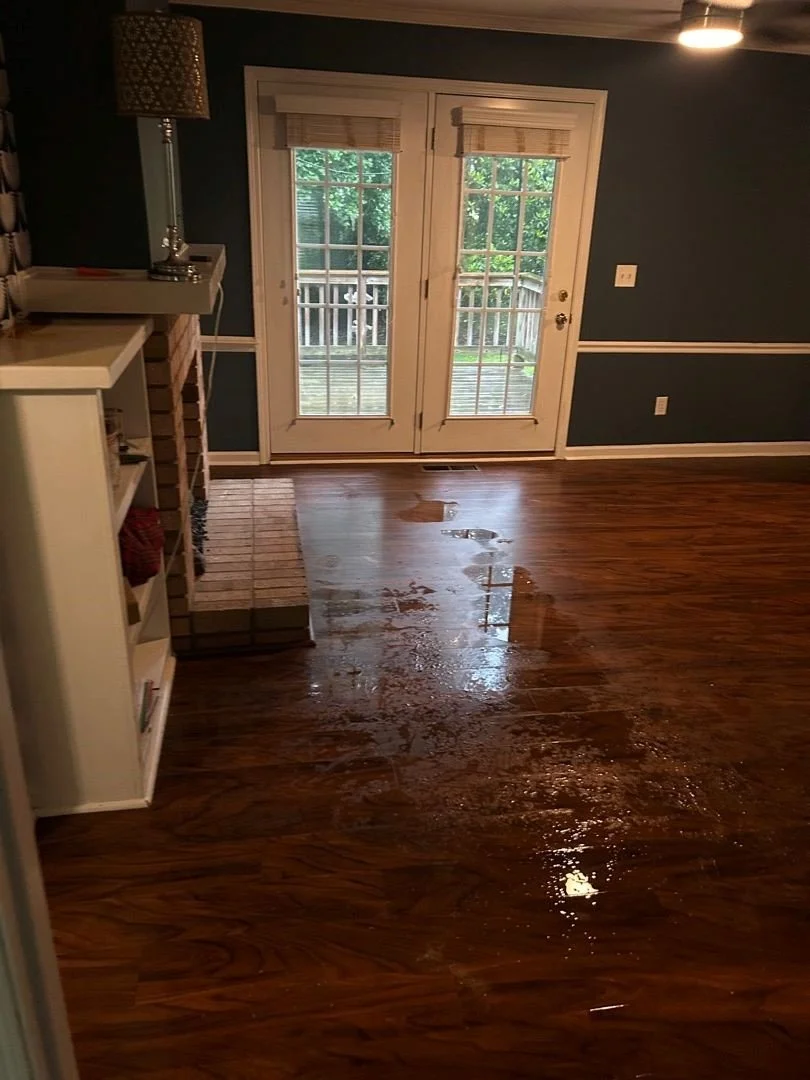 Wet floor from water damage in family room