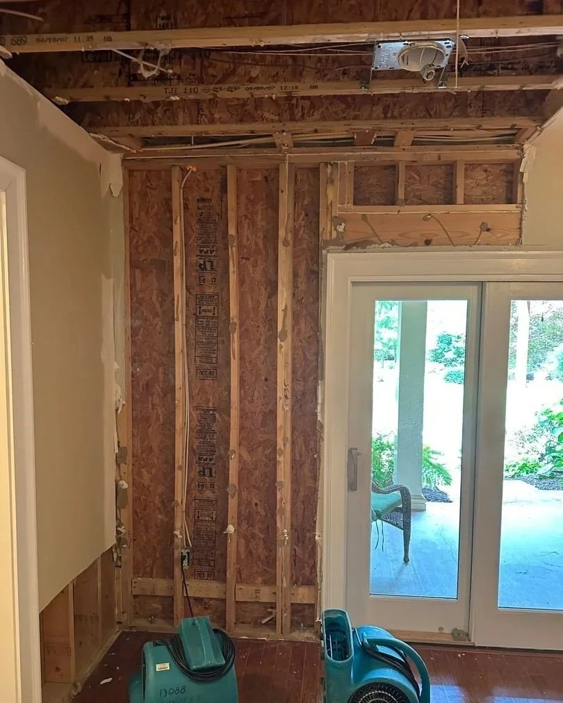 Affected drywall removed from walls and ceiling by ServiceMaster after a pipe burst in the basement ceiling