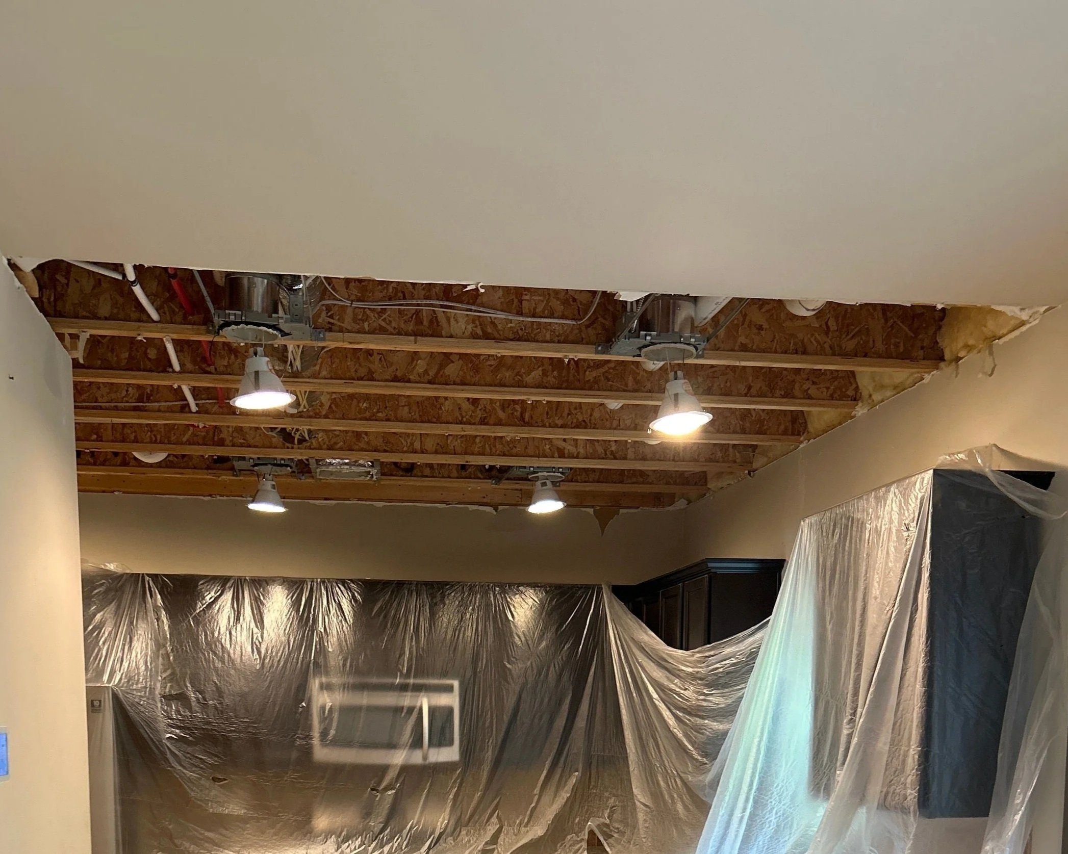 Kitchen ceiling after damaged drywall was removed