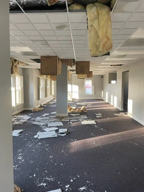 This common area room had ceiling tiles and insulation fall because of water damage from a burst pipe during a freeze