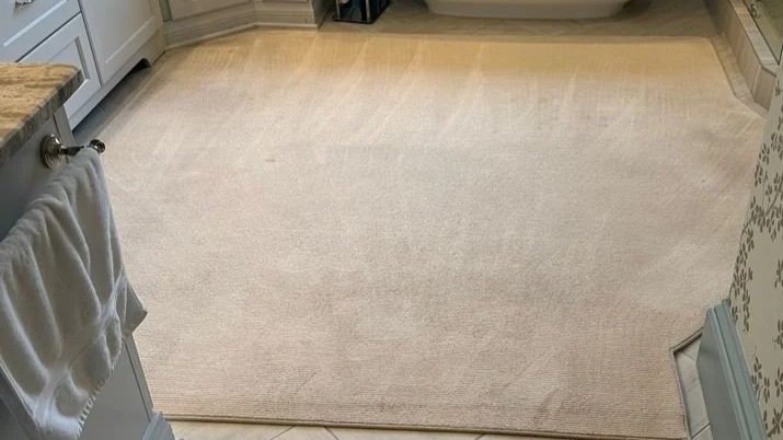 Rug laid over tile floor before ServiceMaster rug cleaning