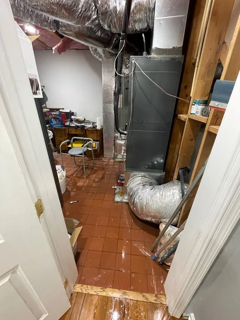Water on floor after water heater expansion tank burst in Utility Room