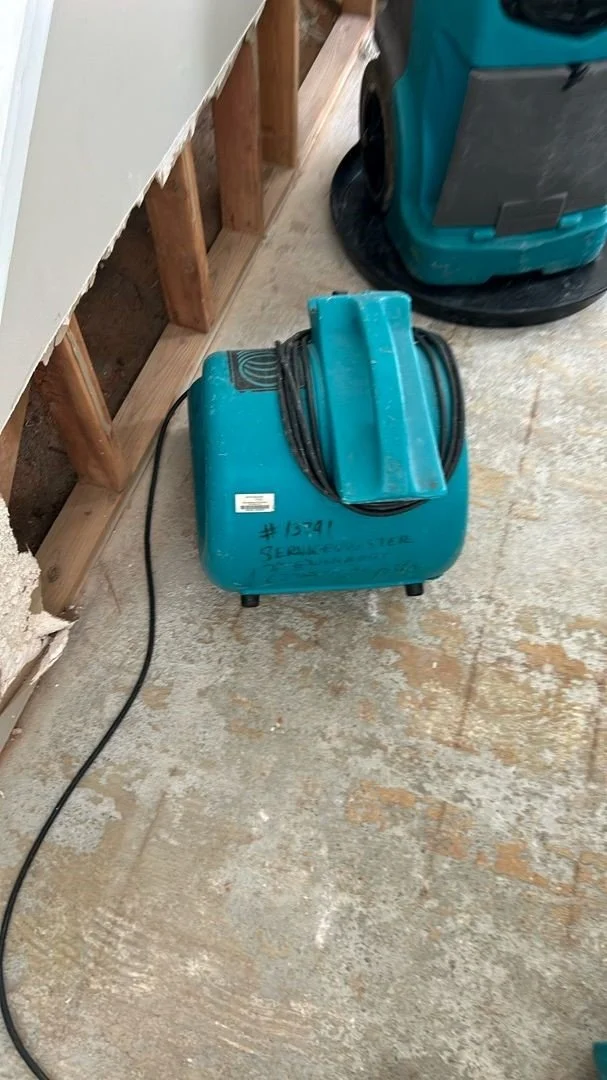 Air mover set in foyer to dry framing after drywall was removed