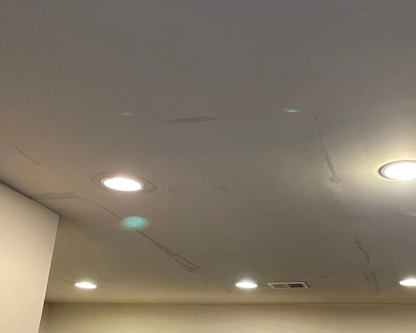 Water damage to kitchen ceiling after bathtub overflow in bathroom above