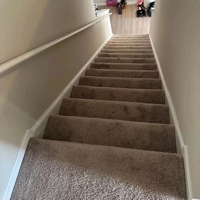 View down staircase before ServiceMaster carpet cleaning