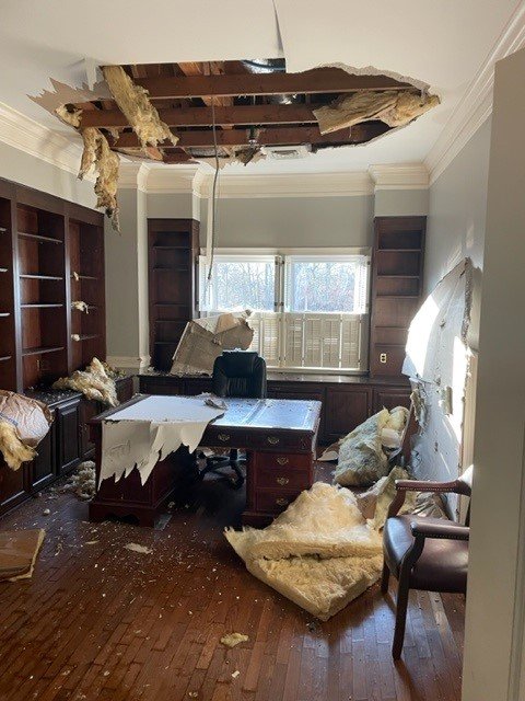 Debris around office after ceiling fell from water damage from a burst pipe