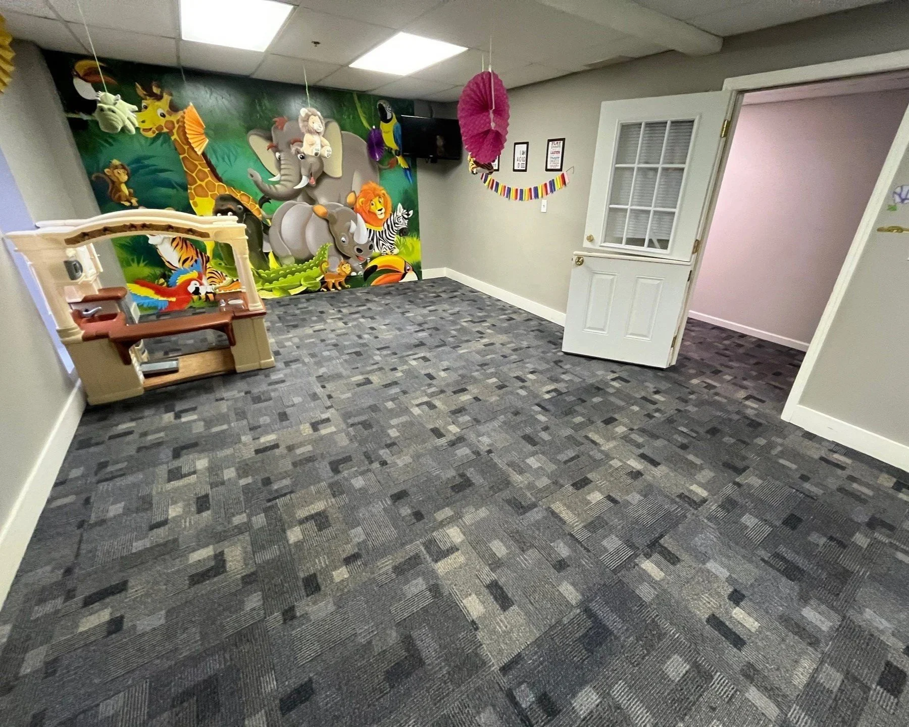 Children's mural on wall behind carpet after ServiceMaster carpet cleaning was performed