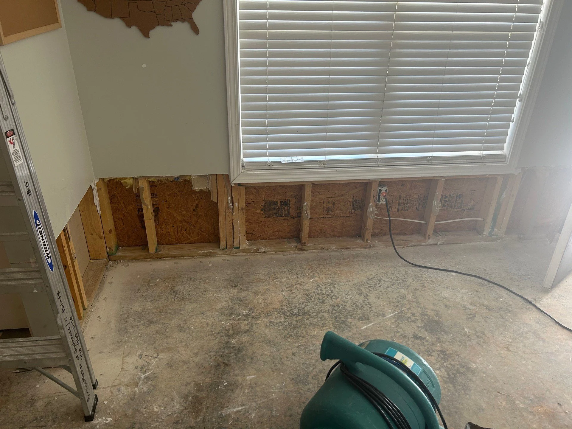 Wet drywall and LVP flooring removed by ServiceMaster