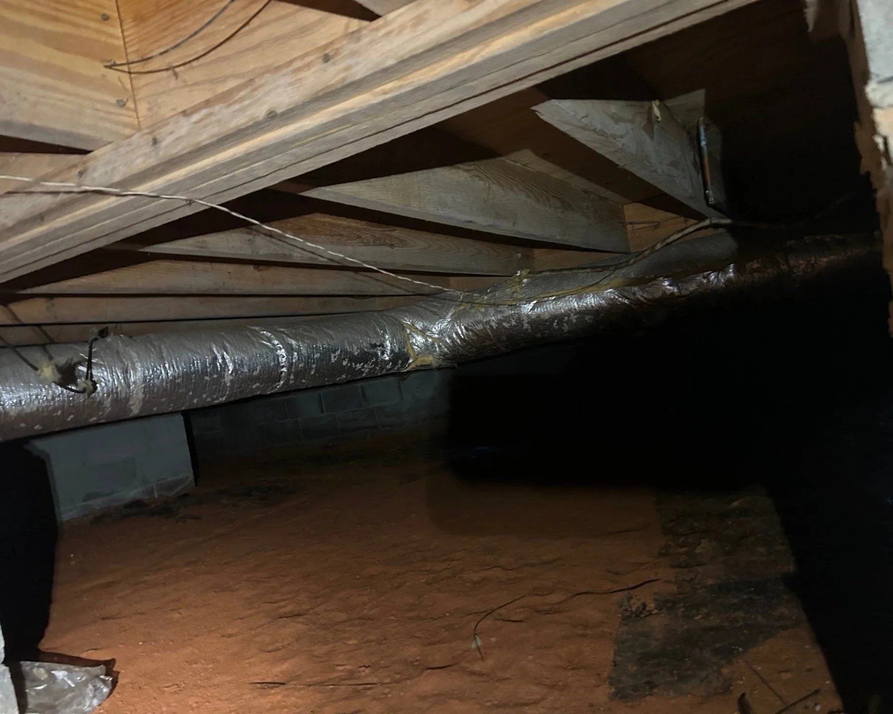 Wet insulation and plastic vapor barrier removed after water ran into crawlspace
