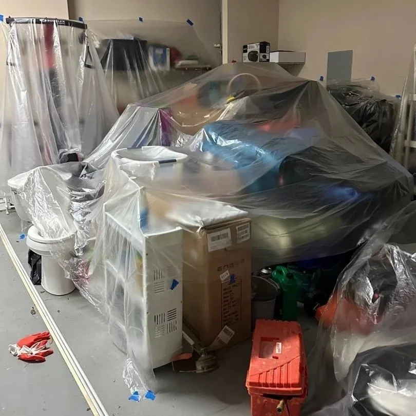 Contents covered with plastic before ceiling drywall can be removed