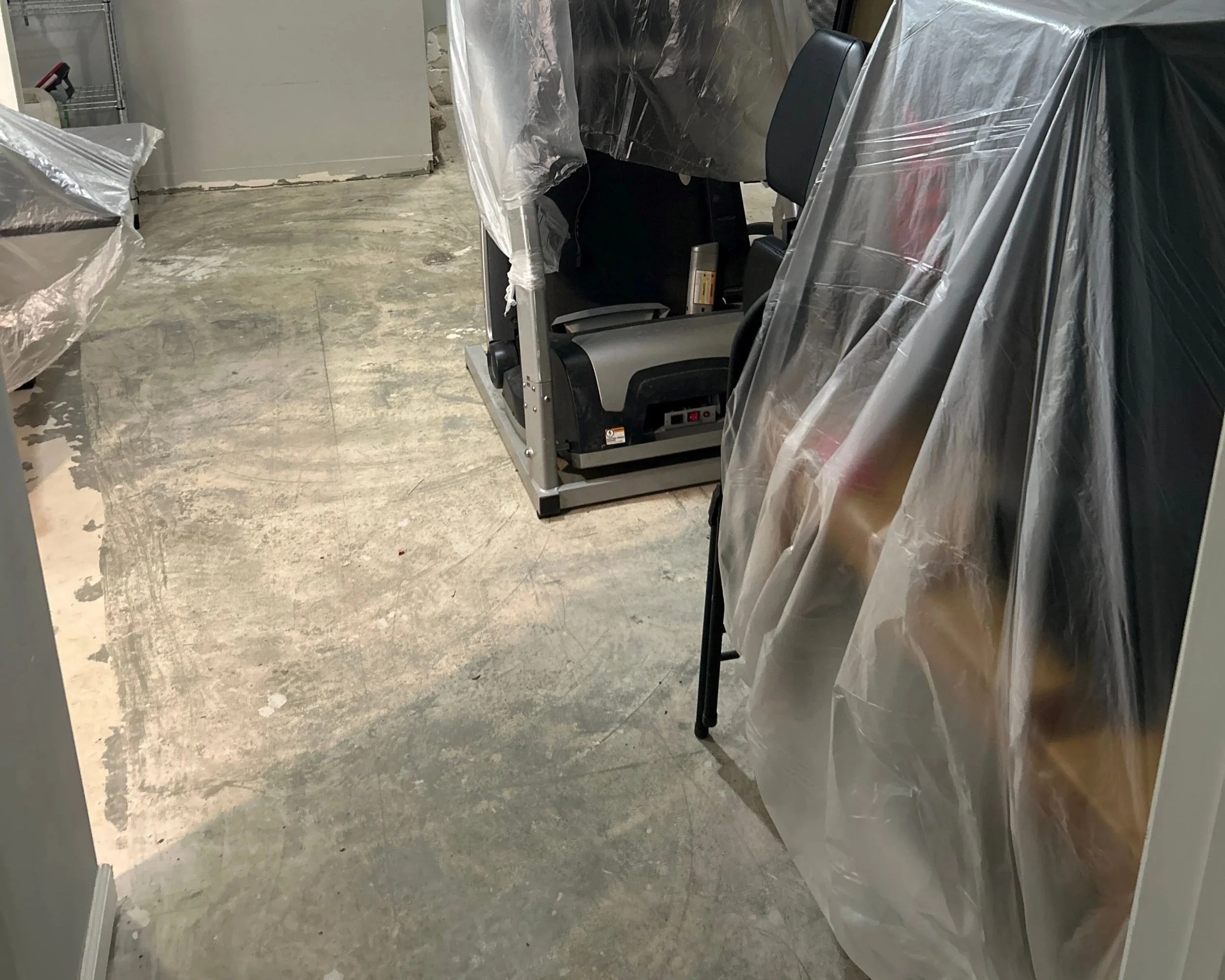 Gym is dried out and exercise equipment is covered to protect during repairs