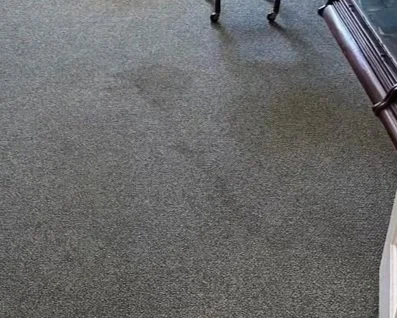 Office carpet with spill stain before ServiceMaster professional carpet cleaning