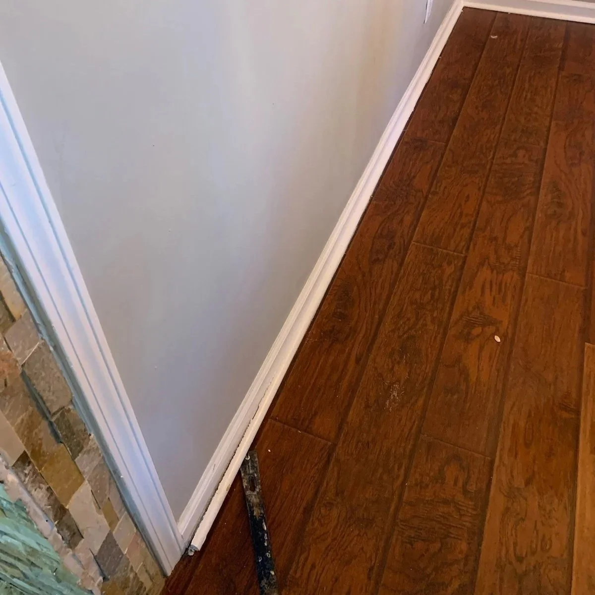 Water damage to wall in dining room after a pipe burst under a sink