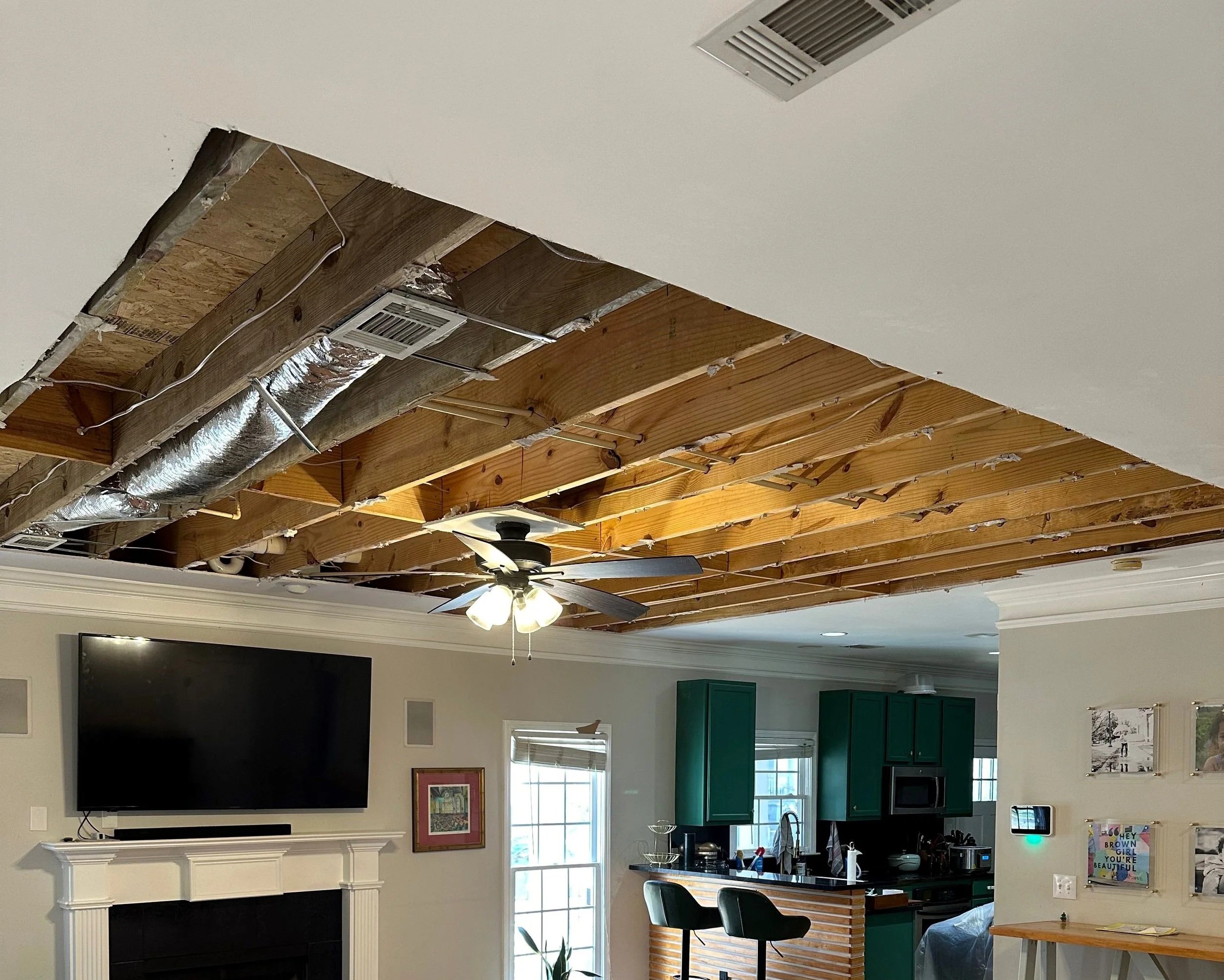 Living room ceiling after damaged drywall was removed and area was sanitized and dried
