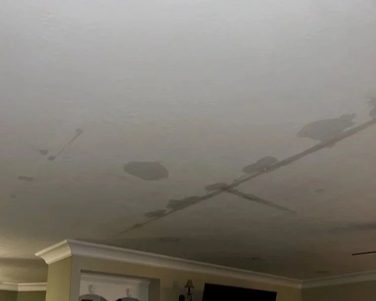 Living room ceiling after a toilet tank cracked on the 2nd floor