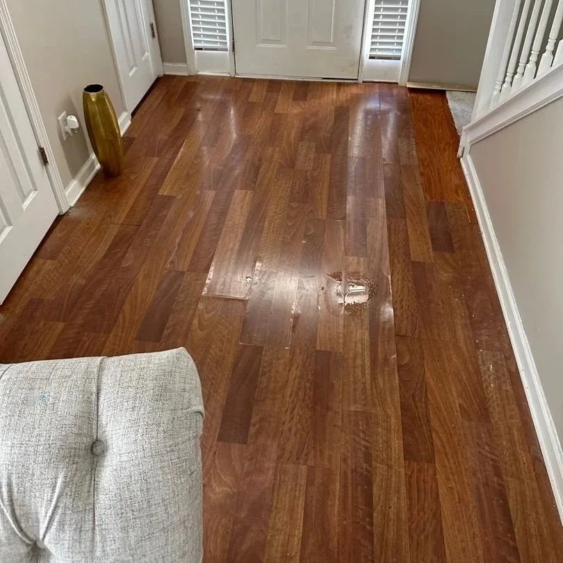 Laminate floor damaged by water in a foyer