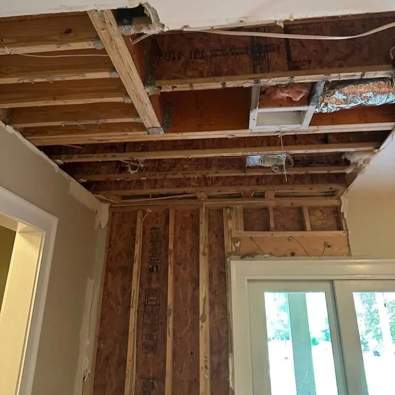 Damaged drywall on walls and ceiling removed by ServiceMaster during water damage mitigation