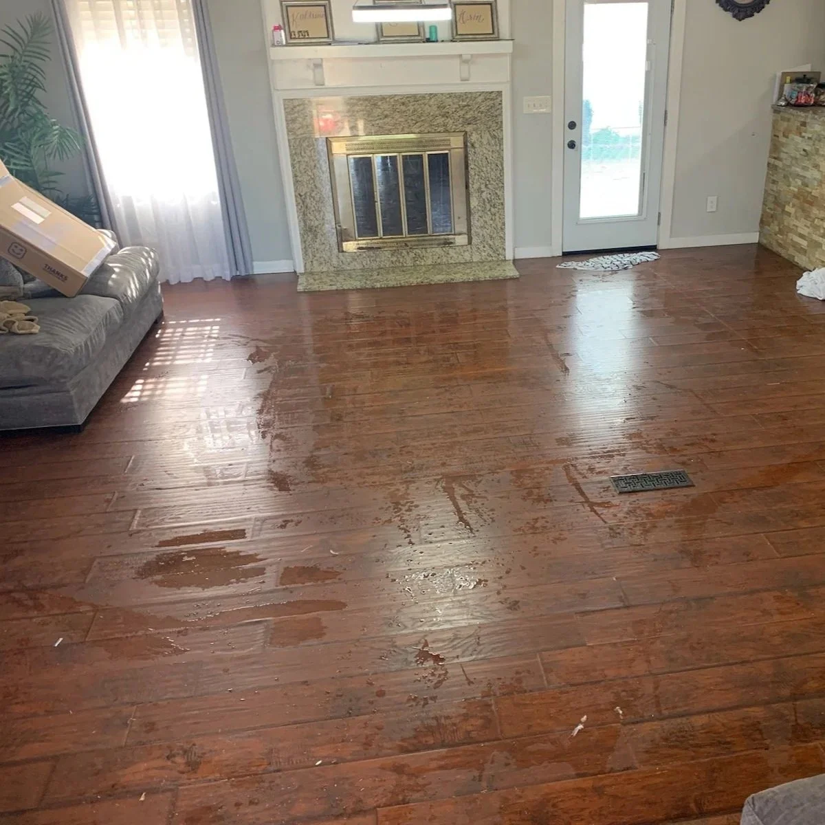 Water on living room floor after pipe burst under a sink