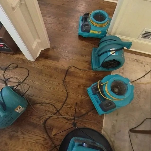 ServiceMaster air movers set to dry hardwood flooring