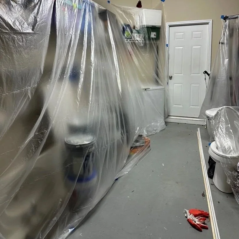 Garage fixtures covered with plastic for protection before ceiling drywall was removed