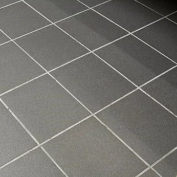 Clean grout line on bathroom floor after ServiceMaster maintenance cleaning