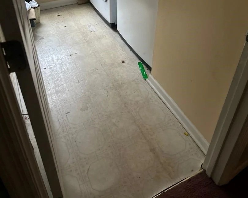 Laundry floor before ServiceMaster removed smoke and soot residue from space heater fire