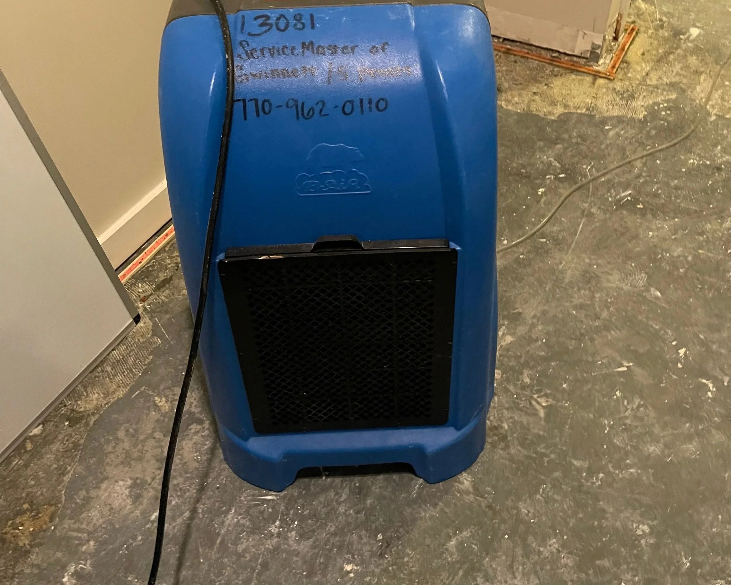 Dehumidifier drying bedroom after dishwasher leaked causing water damage to entire condo