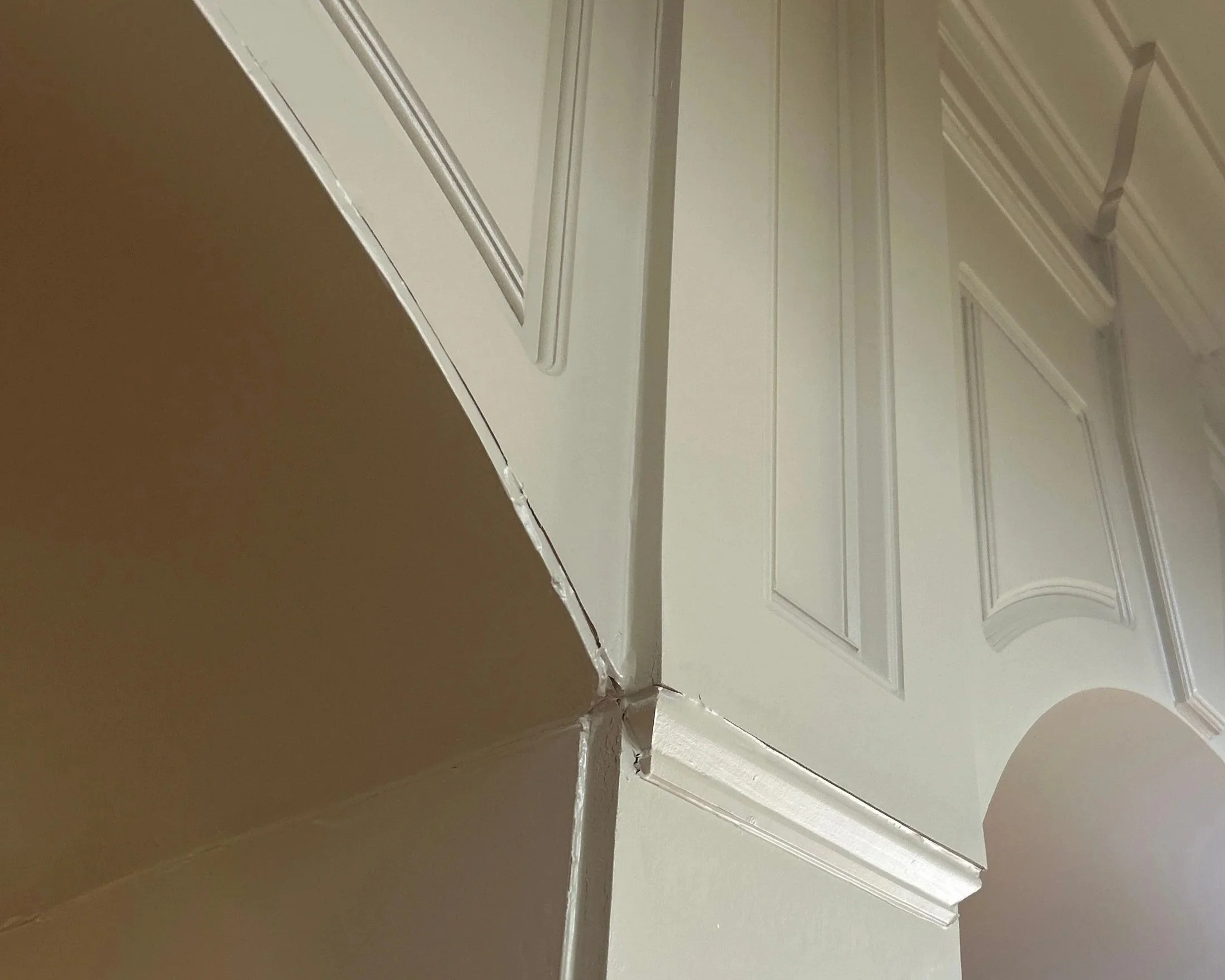Living room arch trim after bathtub overflowed on 2nd floor