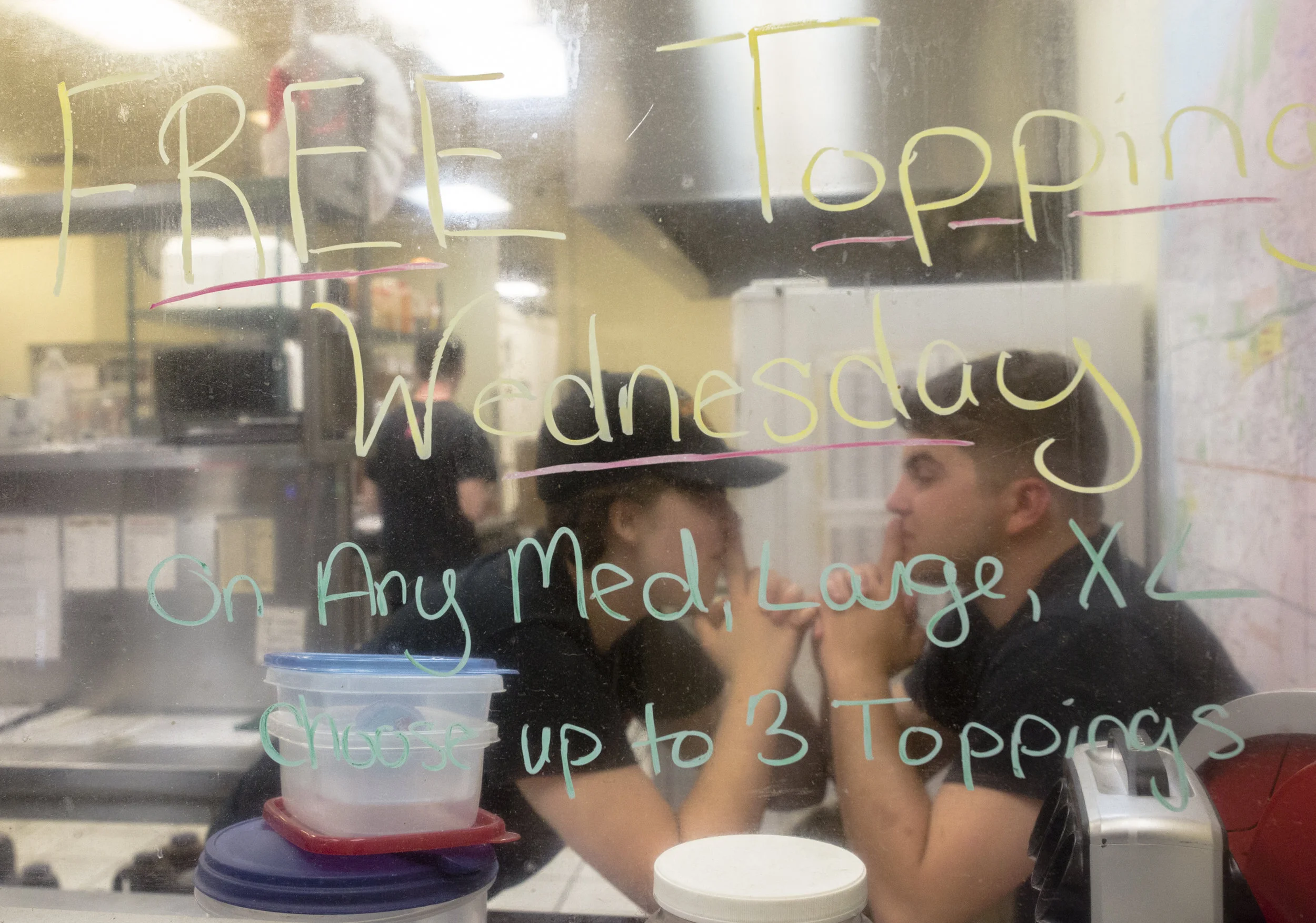A couple works together in a pizza shop in Rochester, N.Y. near Lake Ontaria