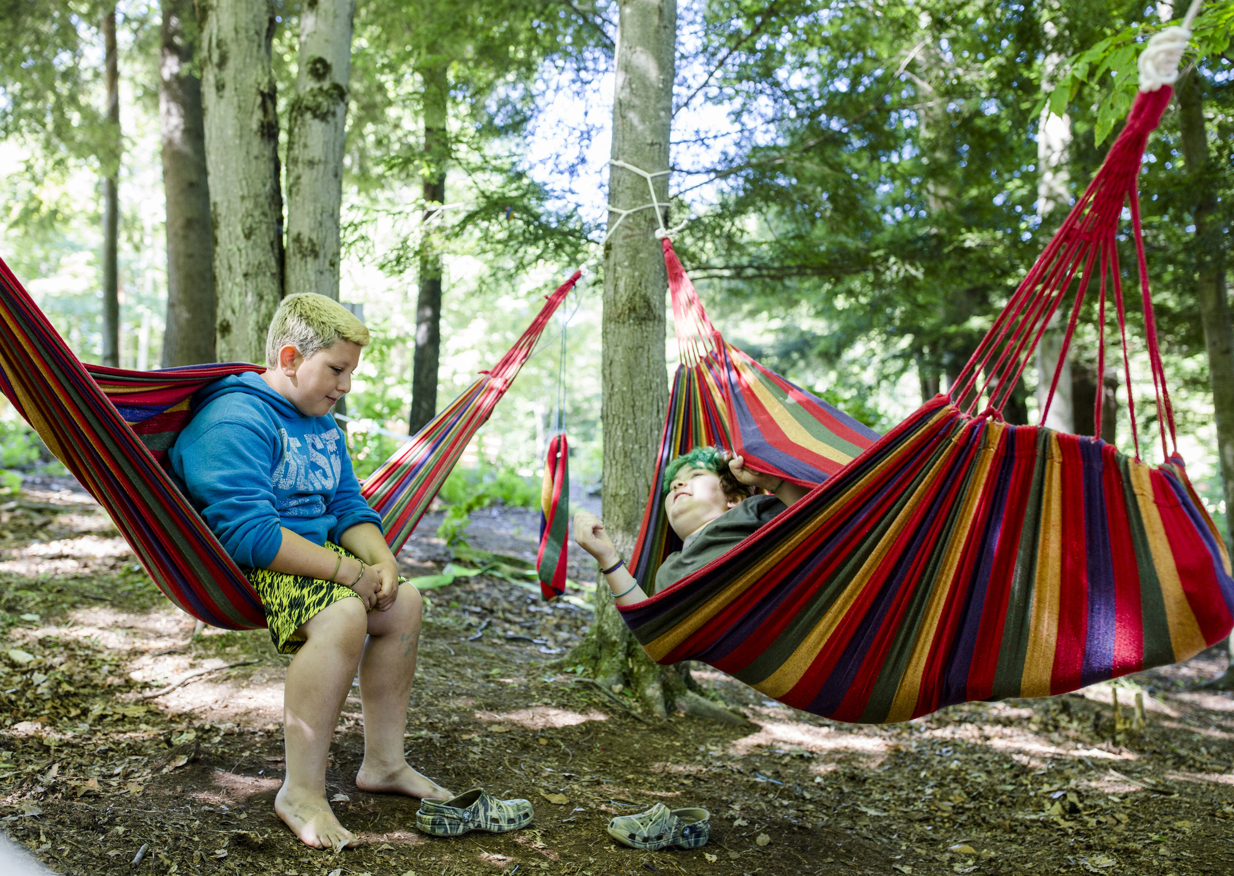  Rocco and Xander talk in the hammocks in the grove. The grove is part of Downtown Stomping Ground, the area surrounding the main field, where campers can move freely between activities. 