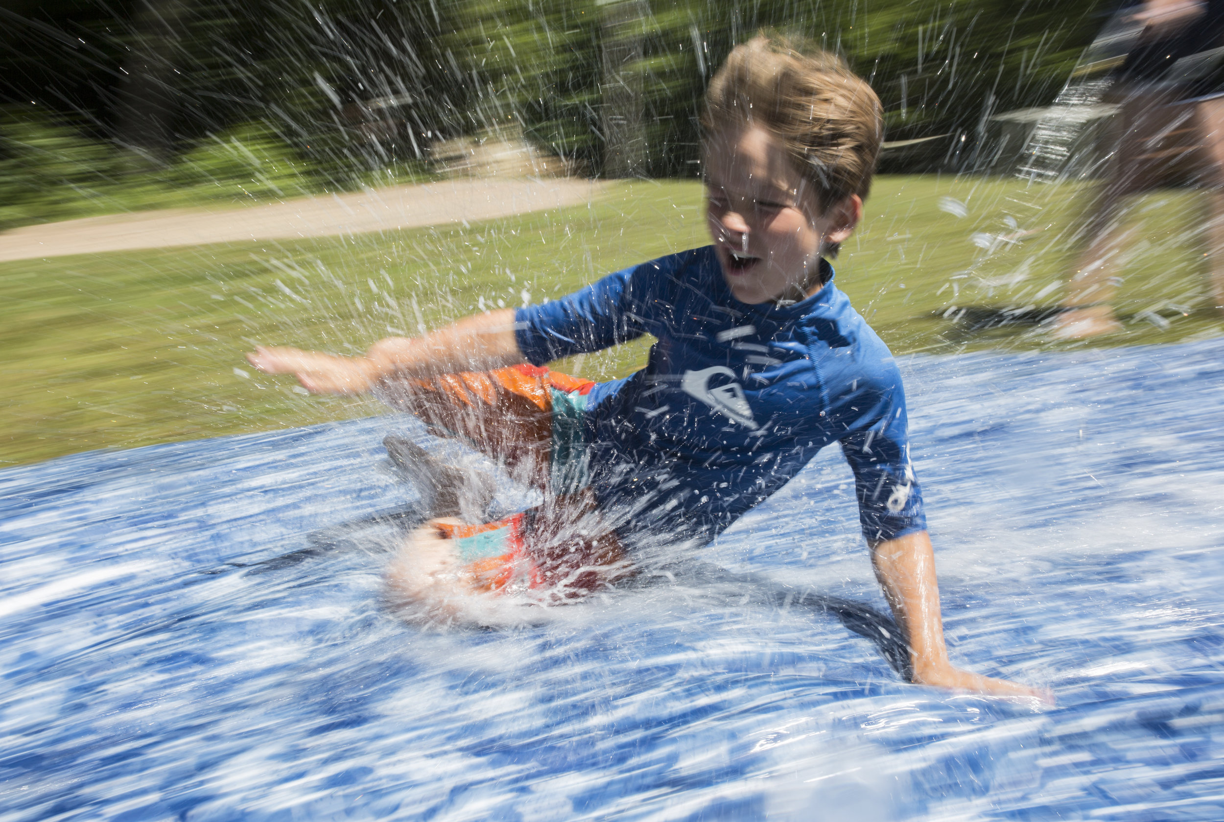  Gideon slides down a giant slip ‘n’ slide. Each week, Stomping Ground has a special event, usually either the slip 'n’ slide or a shaving cream war. 