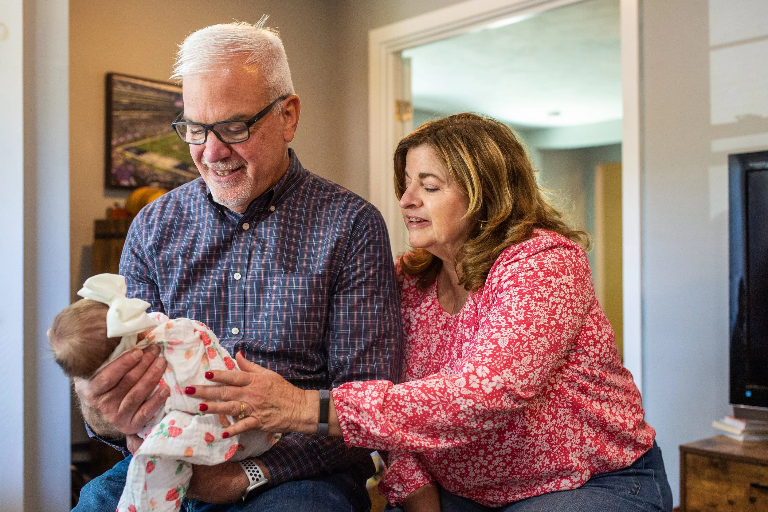 New grandparents hold their newborn granddaughter on Mother's Day in Syracuse New York