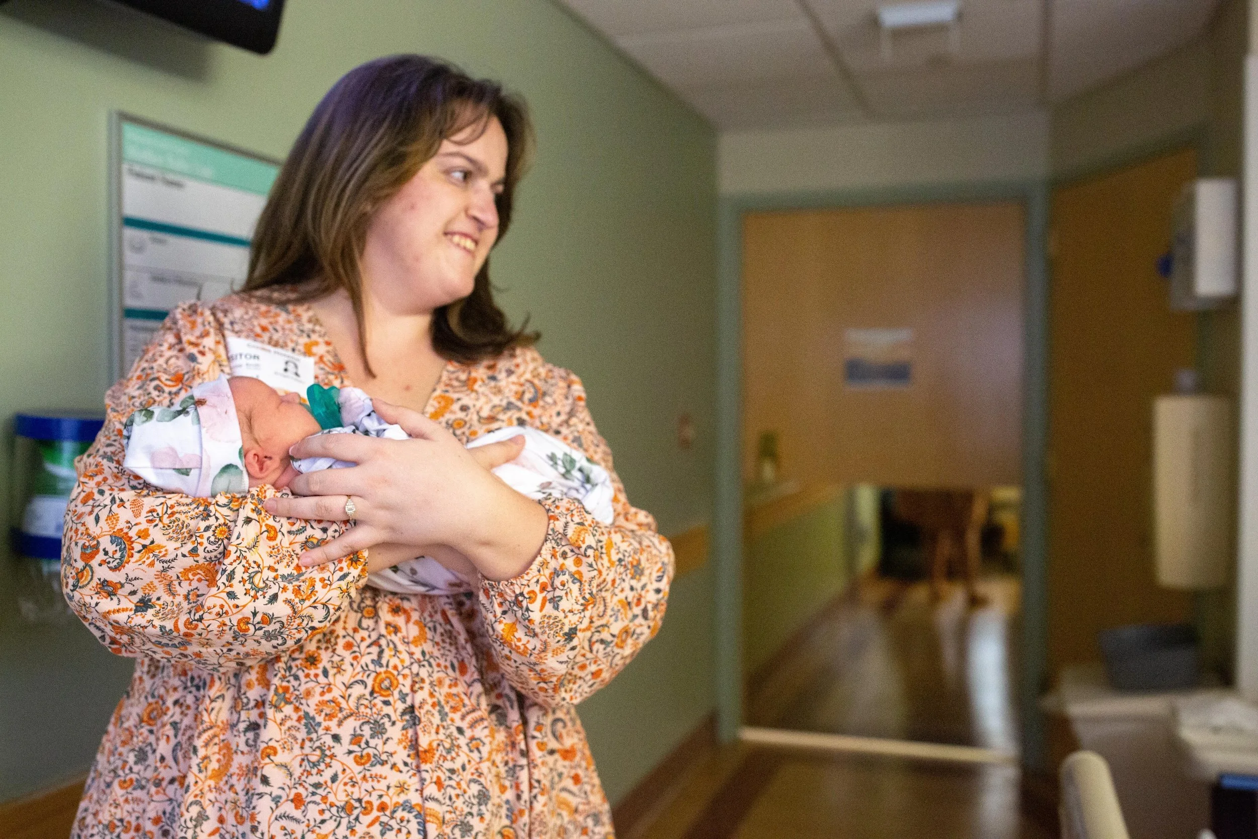 Ithaca area doula, Bridget Reinsko holding her newborn niece in the hospital in Syracuse, N.Y.