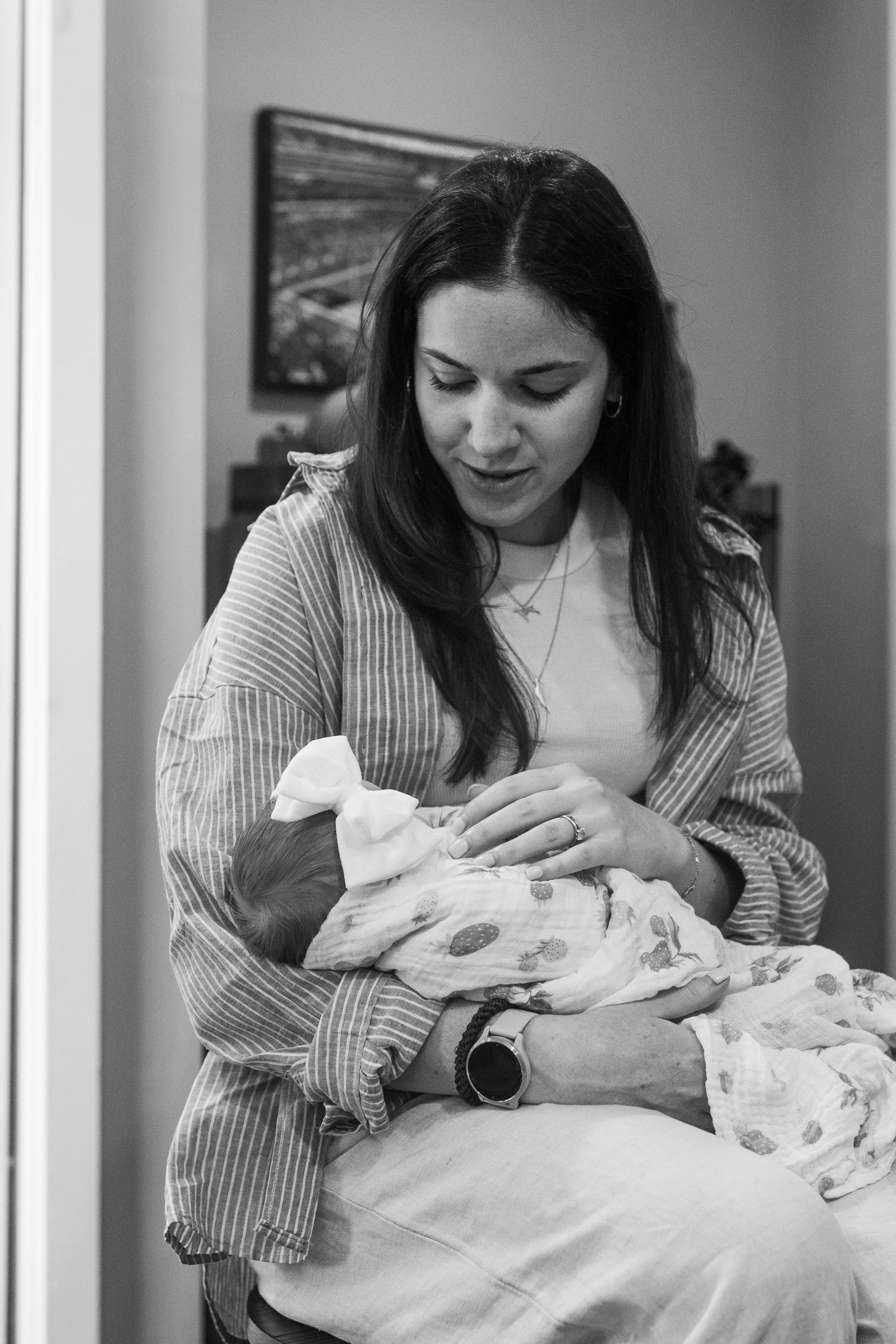 A woman holds her newborn niece during a family gathering for mother's day