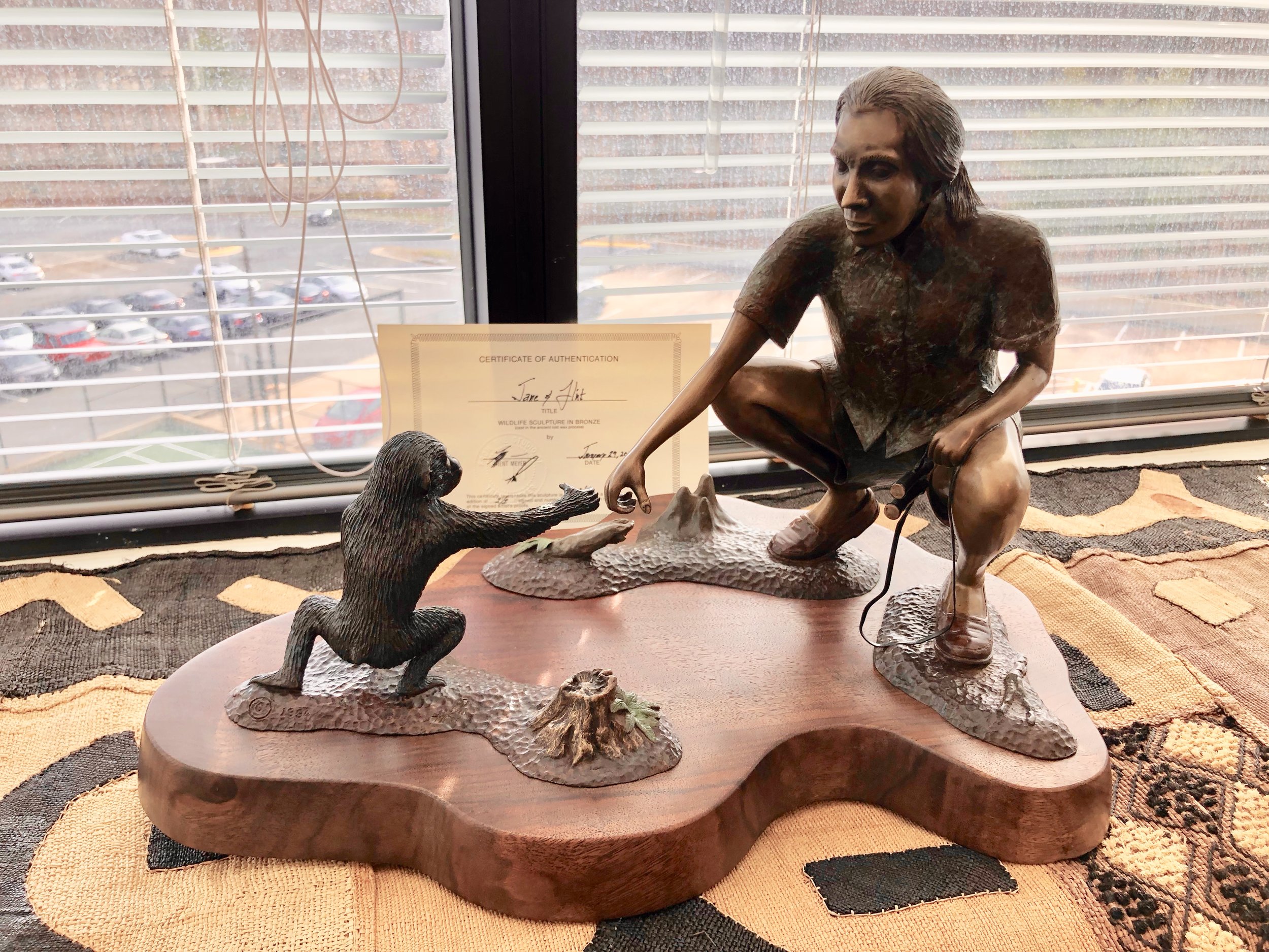 Sculpture of a young, enthusiast, bright observer, Jane Goodall, with a young, enthusiast, bright chimp.