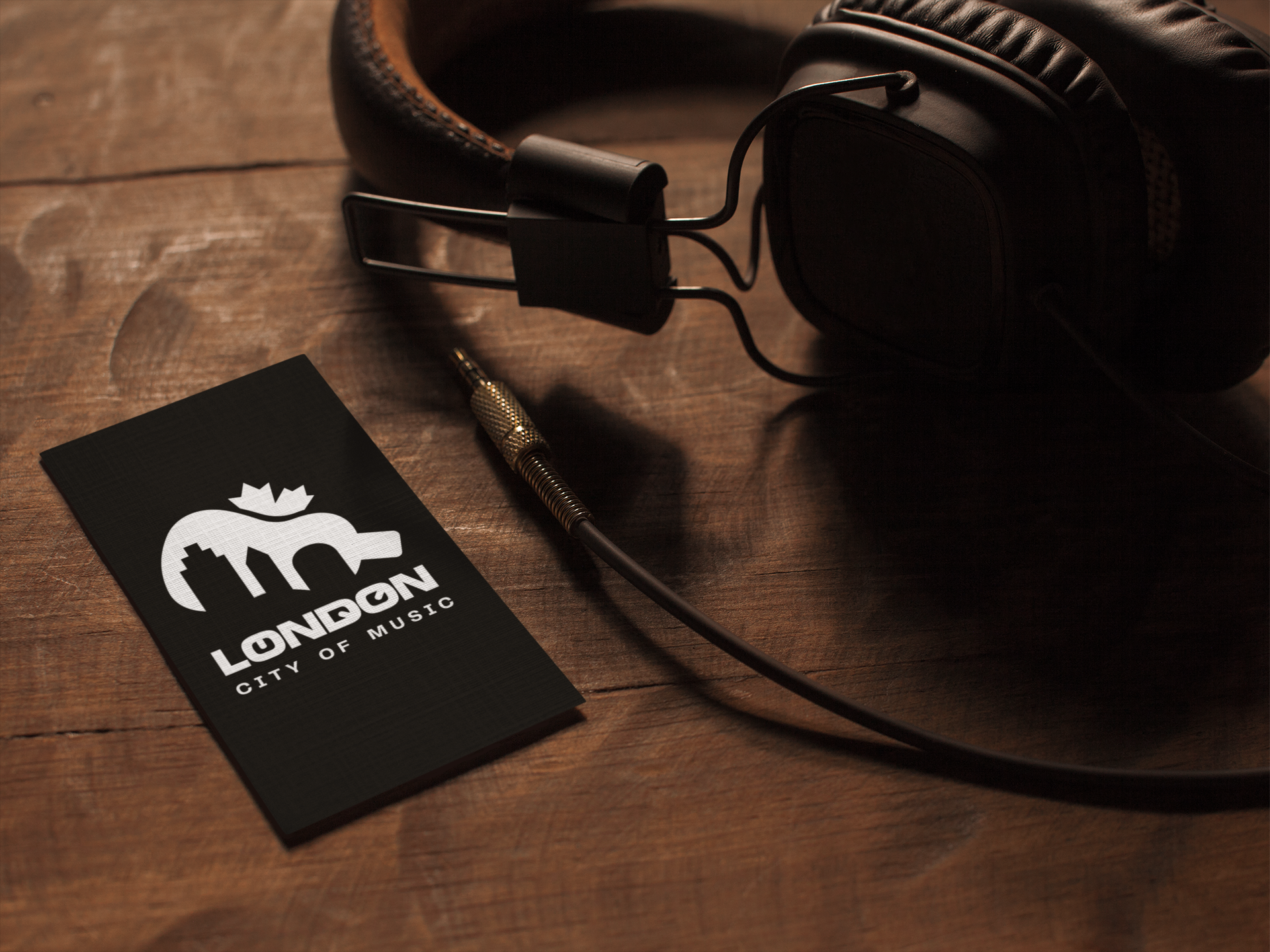 vertical-business-card-template-lying-on-a-wooden-table-next-to-headphones-a14994.png