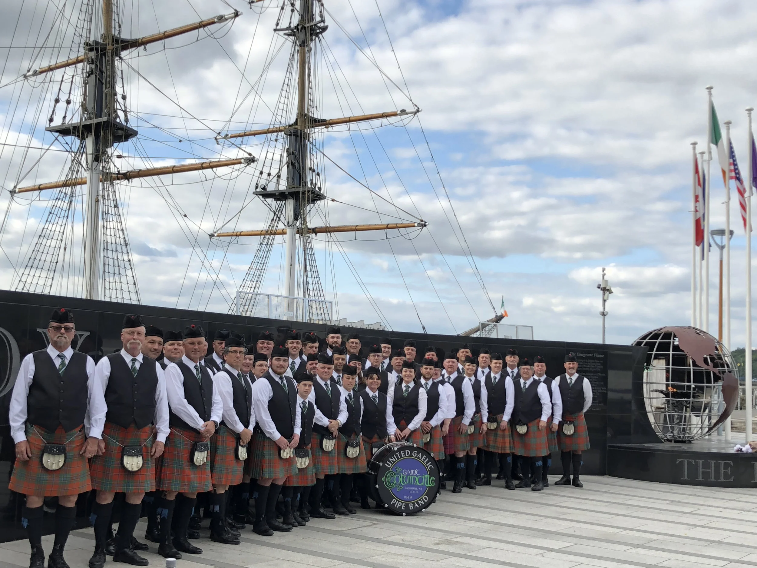 St. Columcille United Gaelic and Columcille School of Piping & Drumming pose before the Dunbrody Emigrant Ship and Museum in New Ross, Co. Wexford, Ireland.