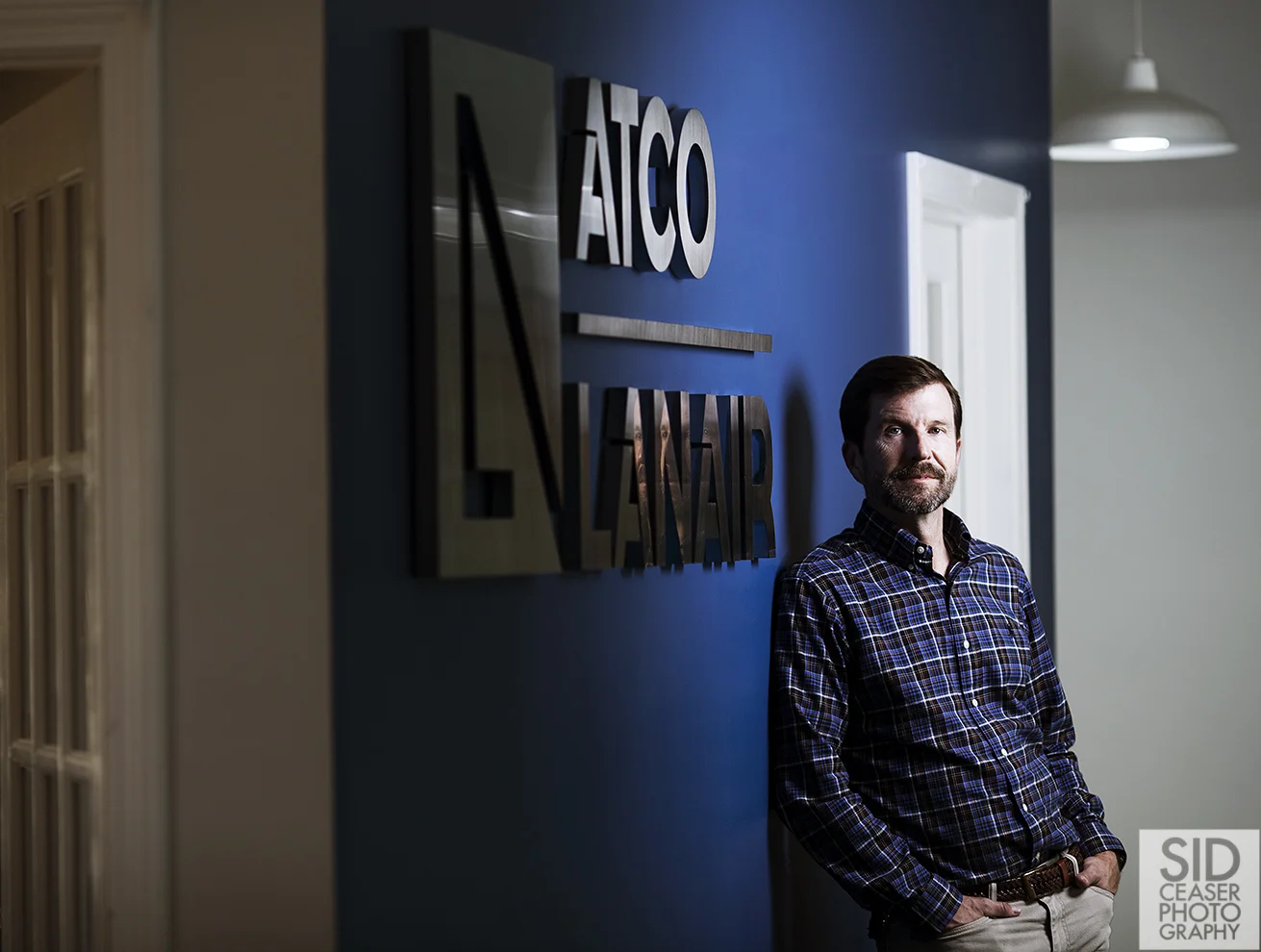 I like how you can see his face in the reflection of the letters on the wall. I also liked how he is lit by my strobe which is a cooler temperature light, and the office to the left had a slightly warmer light in it. I like the transition.