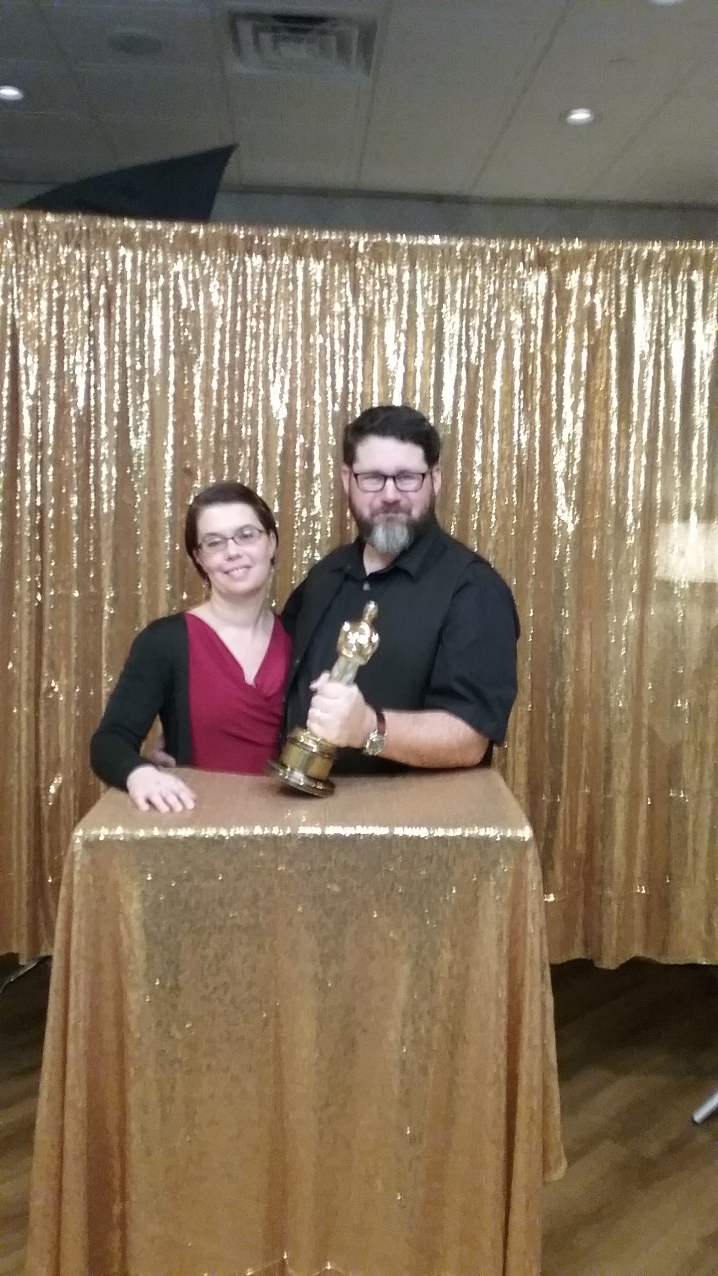 You can see the top of the 50” softbox peeking over the top of the gold backdrop. Behind there was where I was doing the “Academy Portraits”