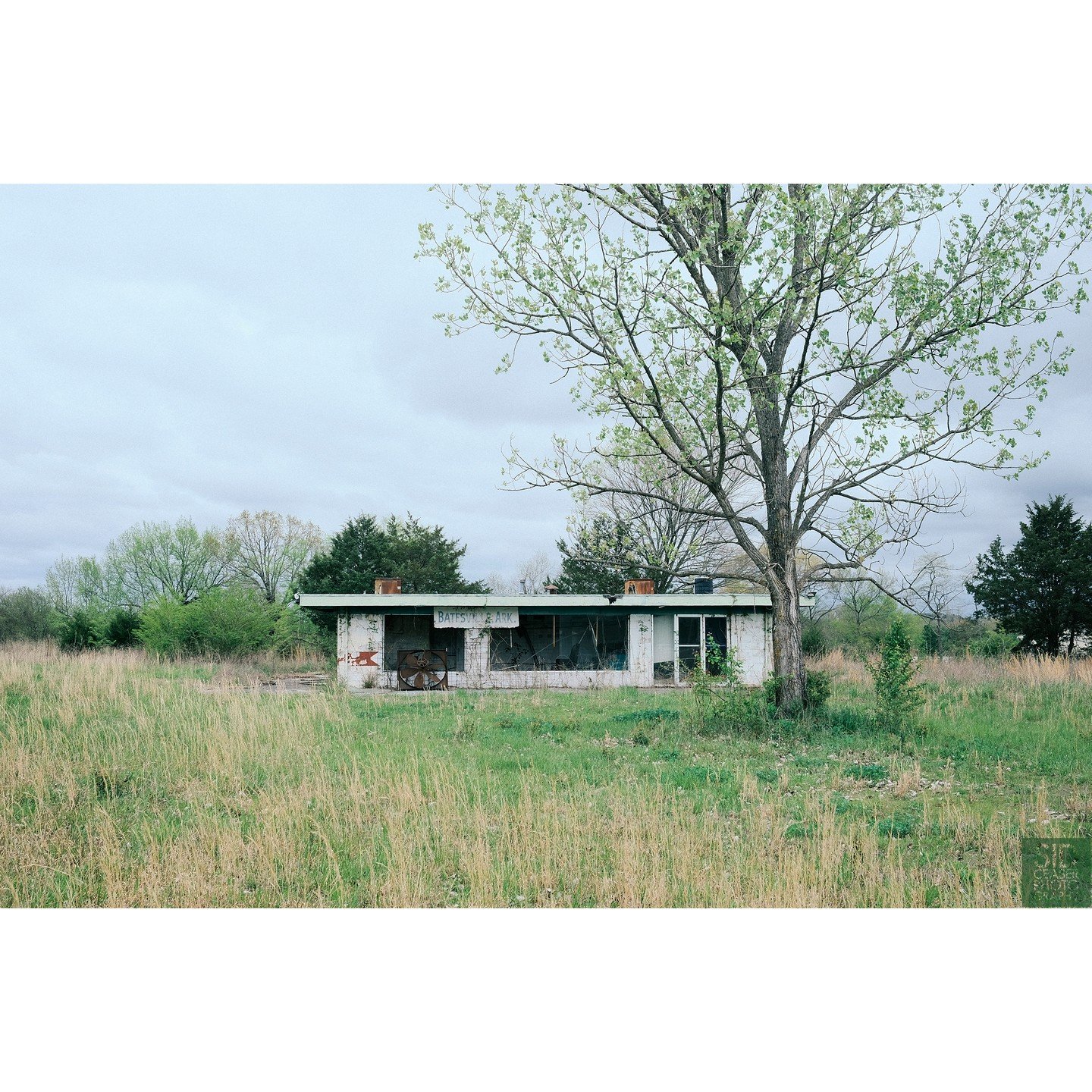 Abandoned Drive-In snack lobby, Batesville, AK. Overgrown with a few snakes running around in the tall grass.

The White River Drive-In was located in Batesville, Arkansas, in the Northern part of the State. It was opened on July 27, 1950 and held 23