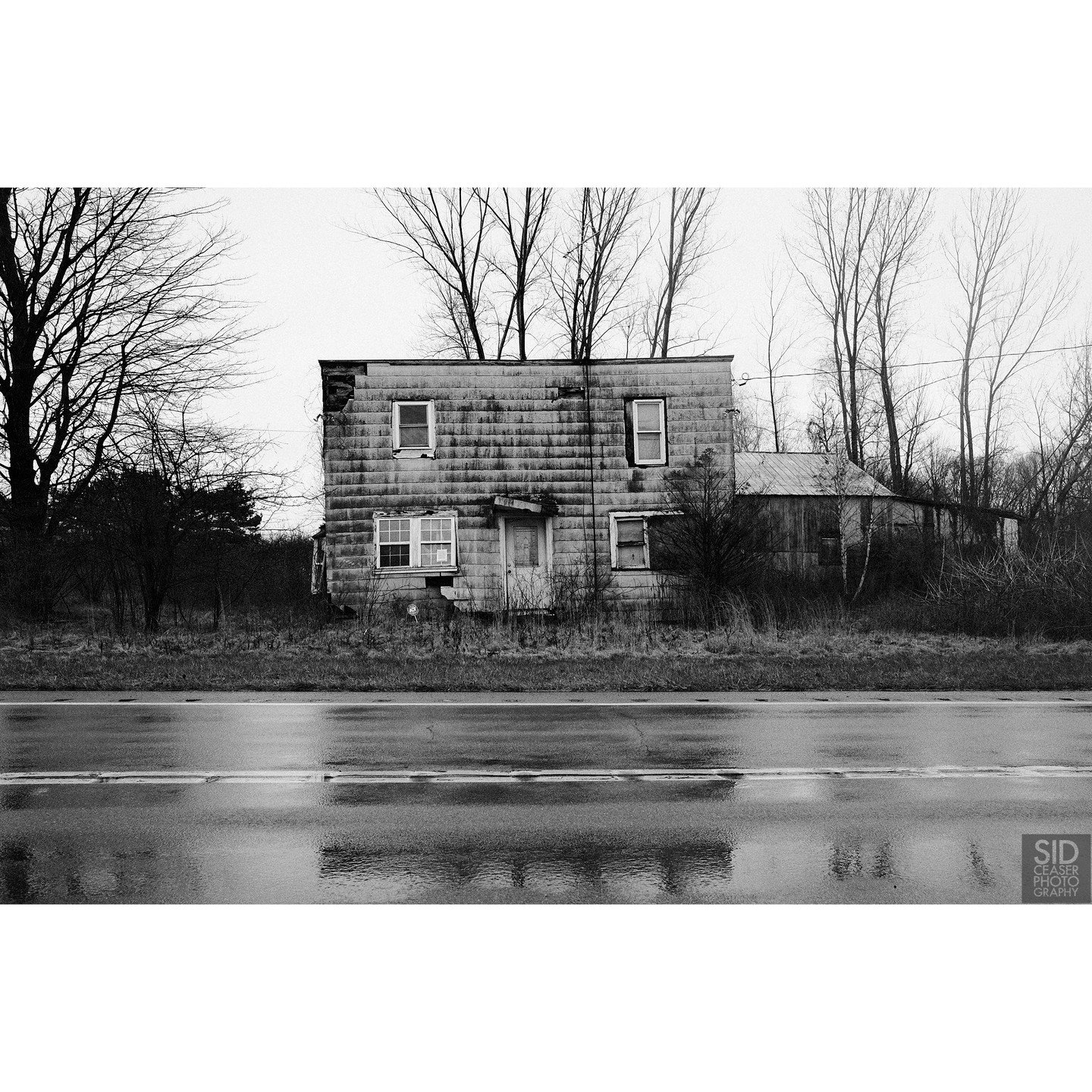 We had left Niagara and it was raining and I didn't think I'd ever find anything to photograph, and we got off on a side road somewhere near Ripley, New York, and suddenly this little square-ish house was sitting there on the side of the road.

I did