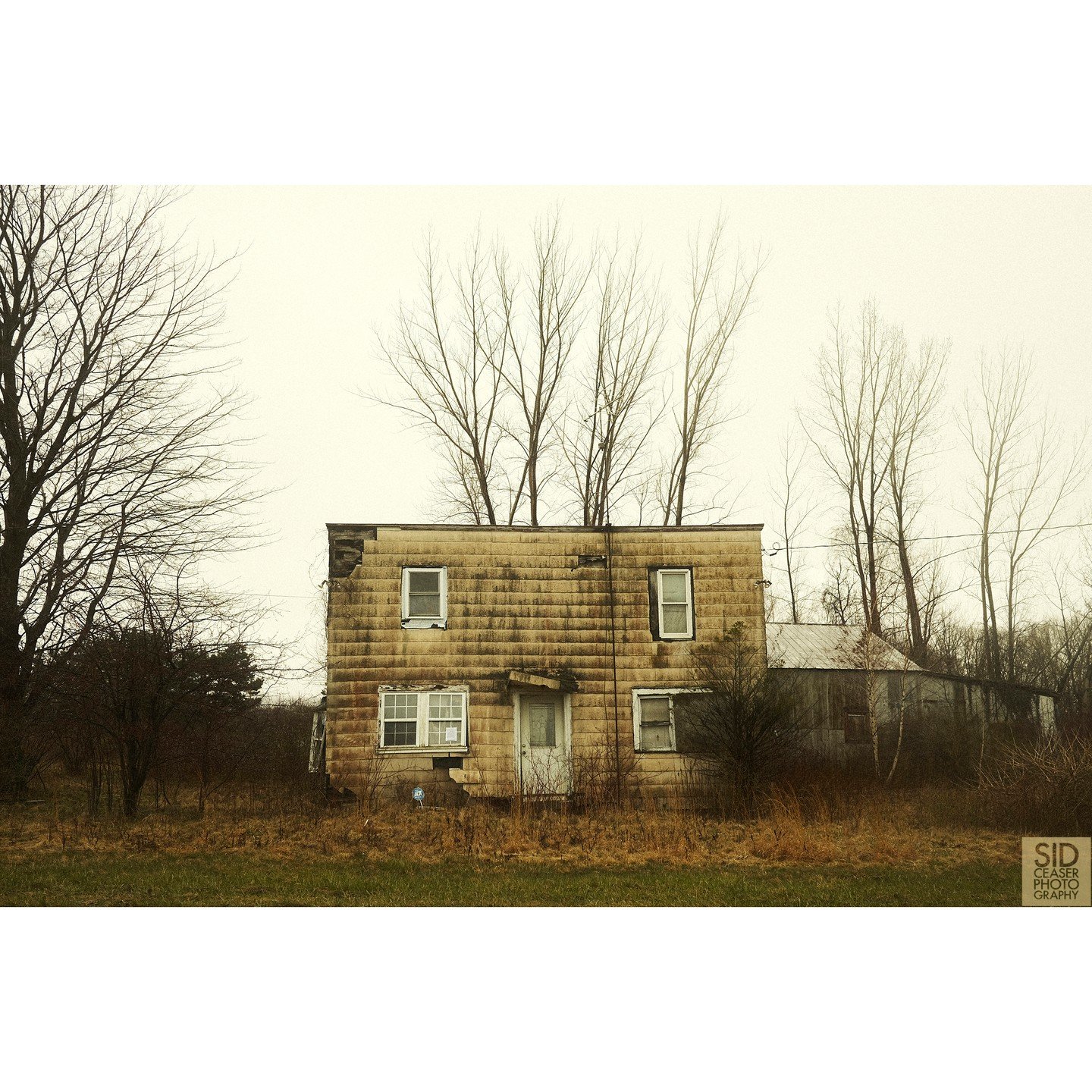 We had left Niagara and it was raining and I didn't think I'd ever find anything to photograph, and we got off on a side road somewhere near Ripley, New York, and suddenly this little square-ish house was sitting there on the side of the road.

I did