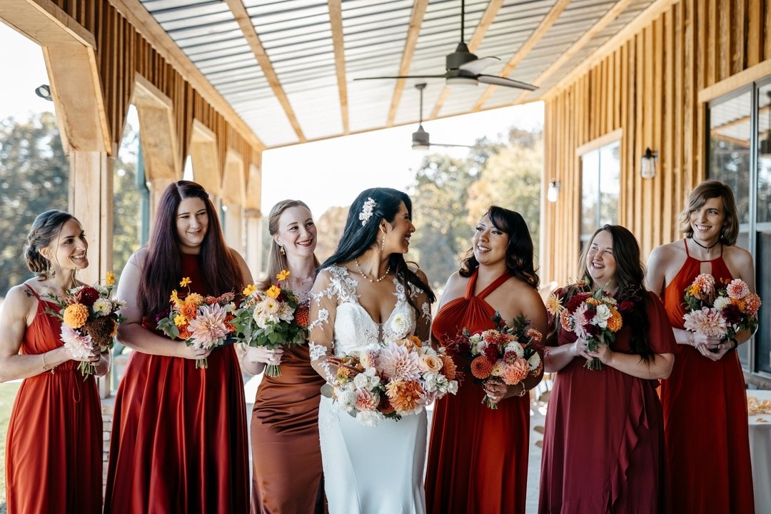 Maria chose coordinating colors for her girls, and we added the bold and bright fall florals to top it off. Notice how the bridal bouquet is a softer, larger version of the bridesmaids? And, like the party and their gowns, no two bouquets are alike. 