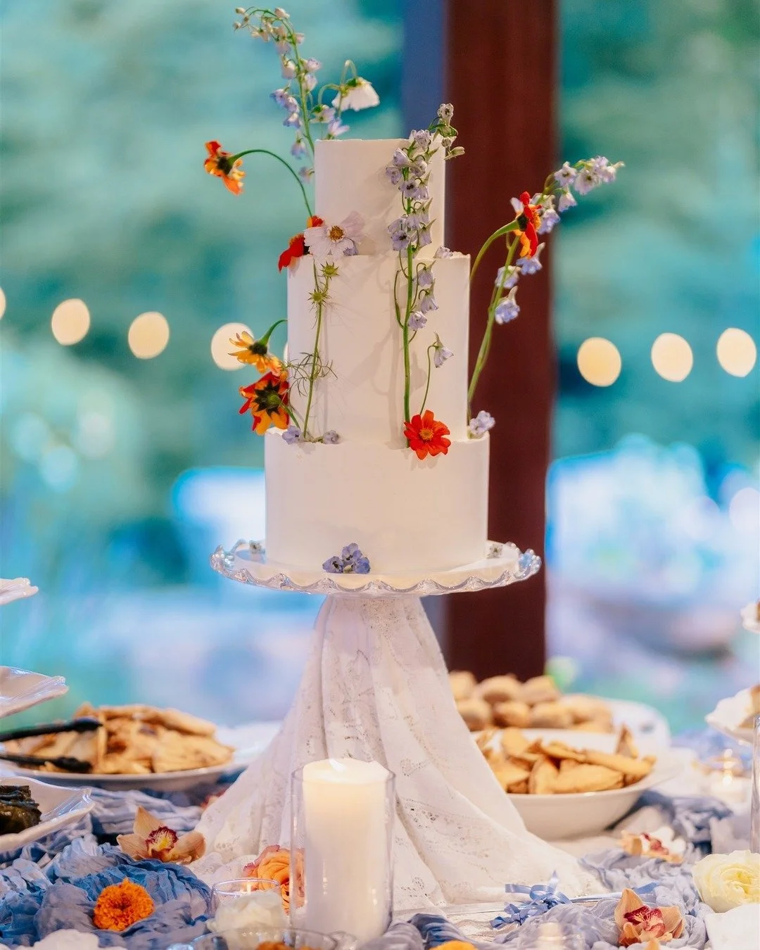 Whimsical florals made this wedding cake extra special &mdash; with dainty orange and yellow wildflowers and soft blue delphiniums adding the perfect touch.

local Virginia flowers | whimsical floral design | Virginia wedding florist | fine art flori