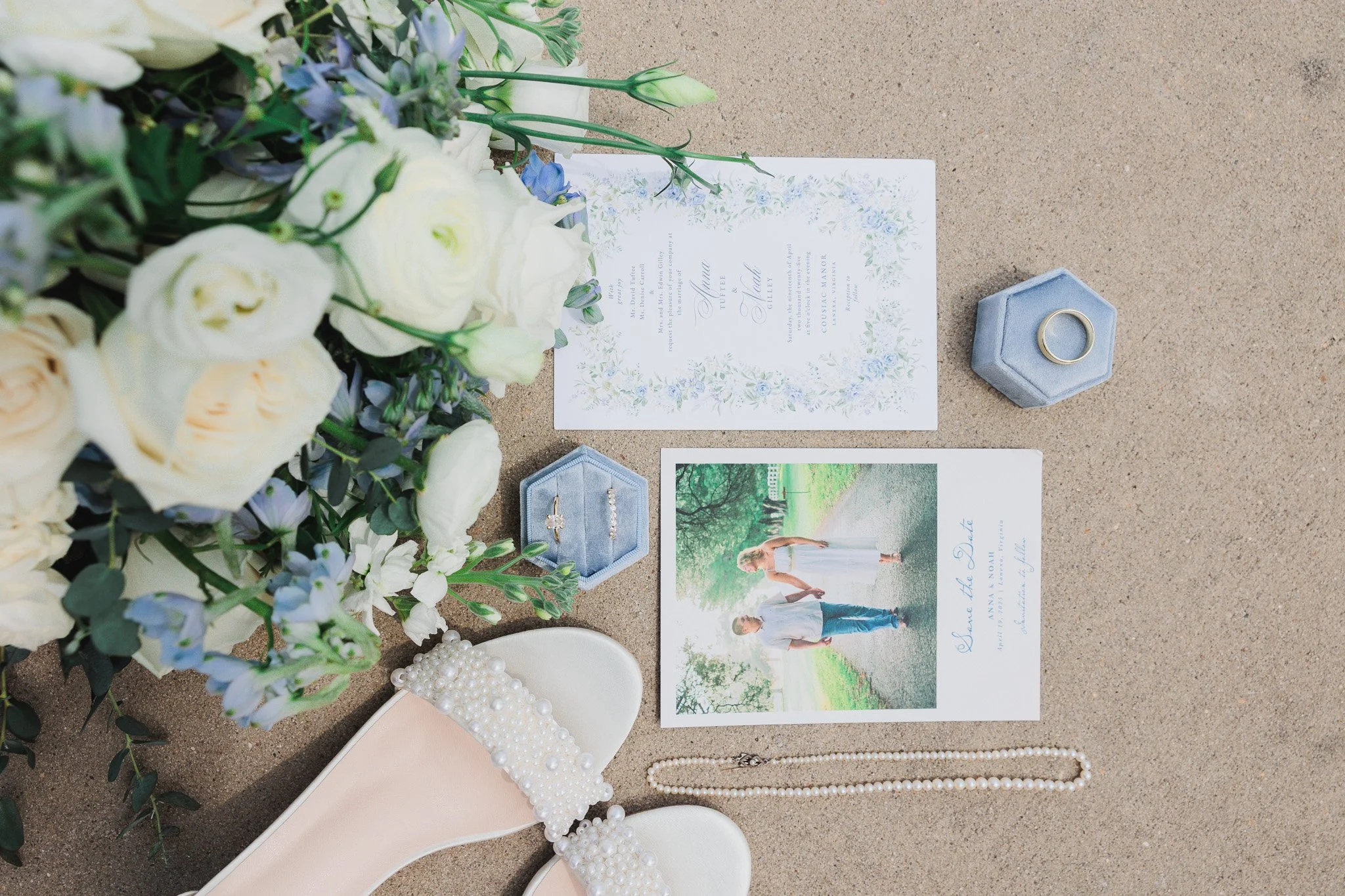 overhead detail wedding photo with invitation card, ring, bride heels, and bouquet